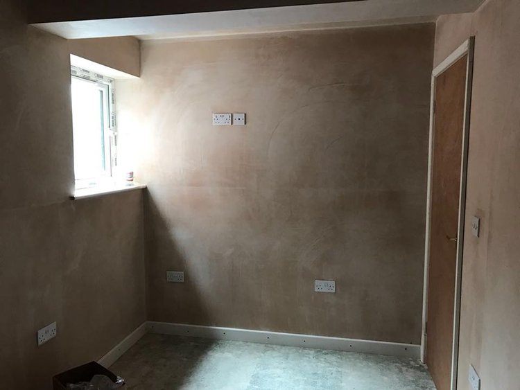 A picture of a room with newly plastered walls