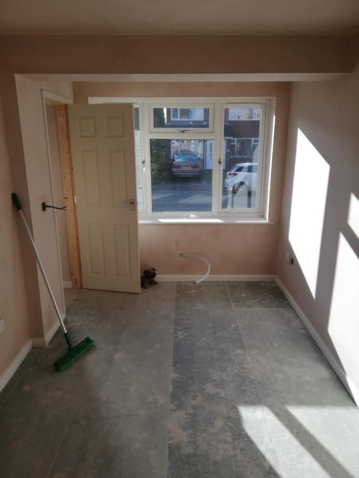 A picture of a newly built room extension with plastered walls