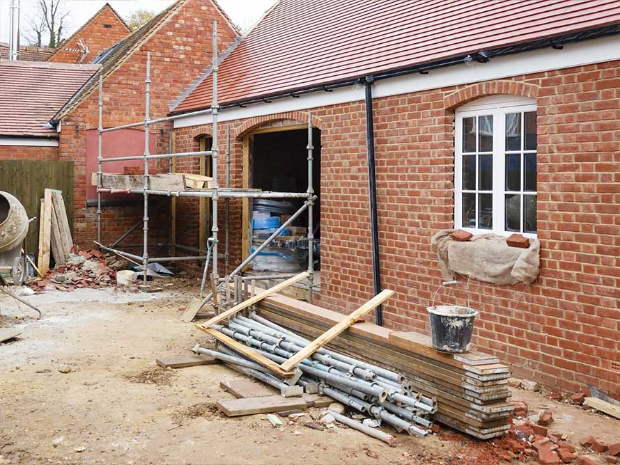 A picture of red brick house and scaffolding